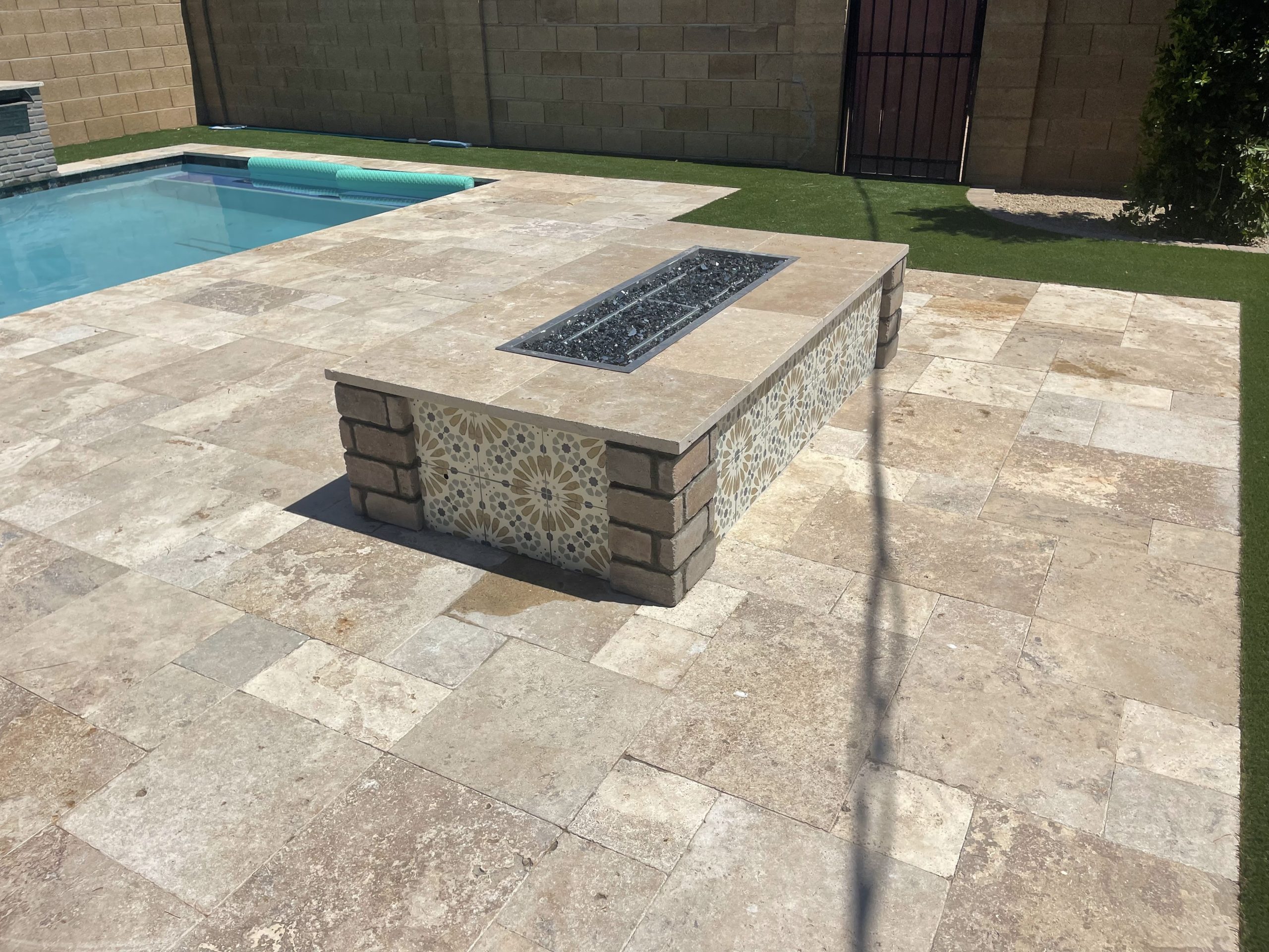 Custom pool with travertine paver deck and fire feature by AZ Pool Concepts in Phoenix, AZ